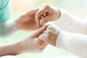 Elderly hands held by Guardian photo. 